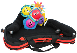Image shows a Curve Connect tray bag with red trim on a flat surface, with a brightly-coloured smiling flower toy attached to the tray surface